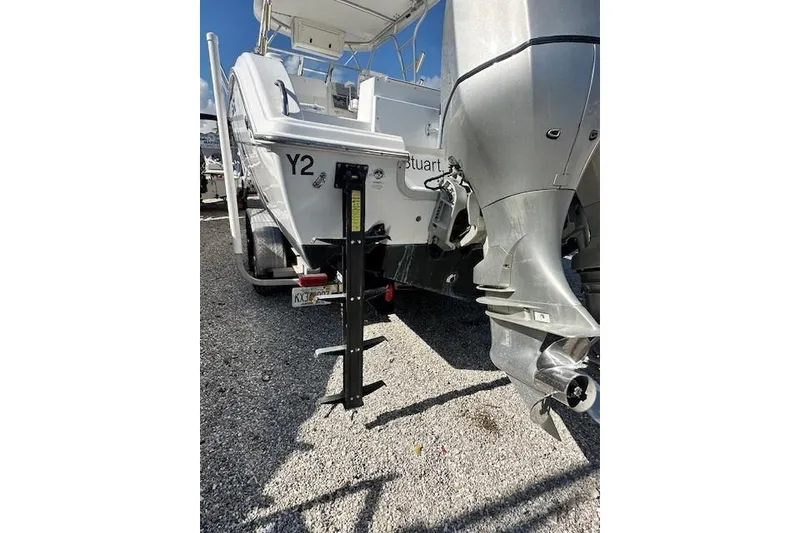 Slide: The Image of 2005 Sea Fox 287 Walkaround boat rear view with outboard motor and trailer. - 9