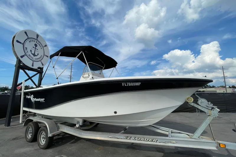 Slide: The Image of 2004 Fishmaster Travis Edition 220 boat on trailer under blue sky. - 0