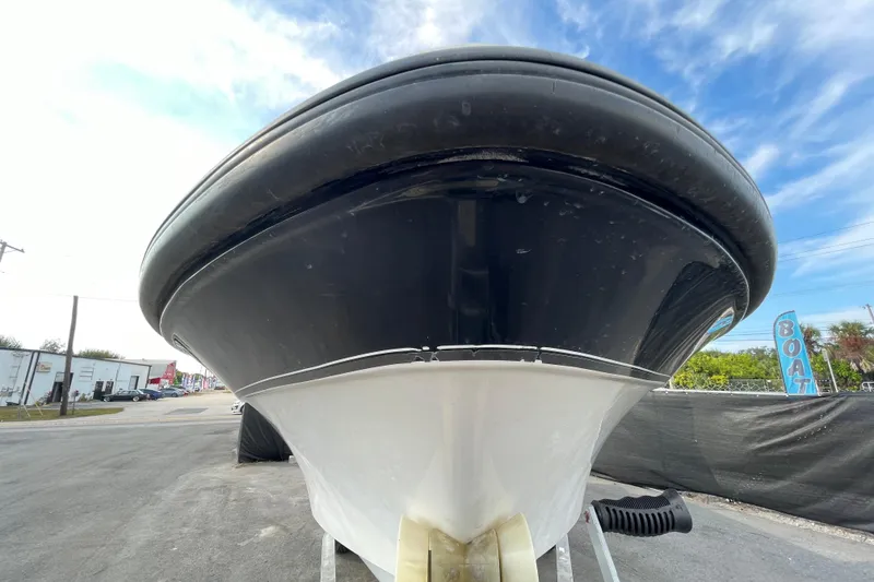 Slide: The Image of Front view of a 2004 Fishmaster Travis Edition 220 boat, black and white hull. - 1
