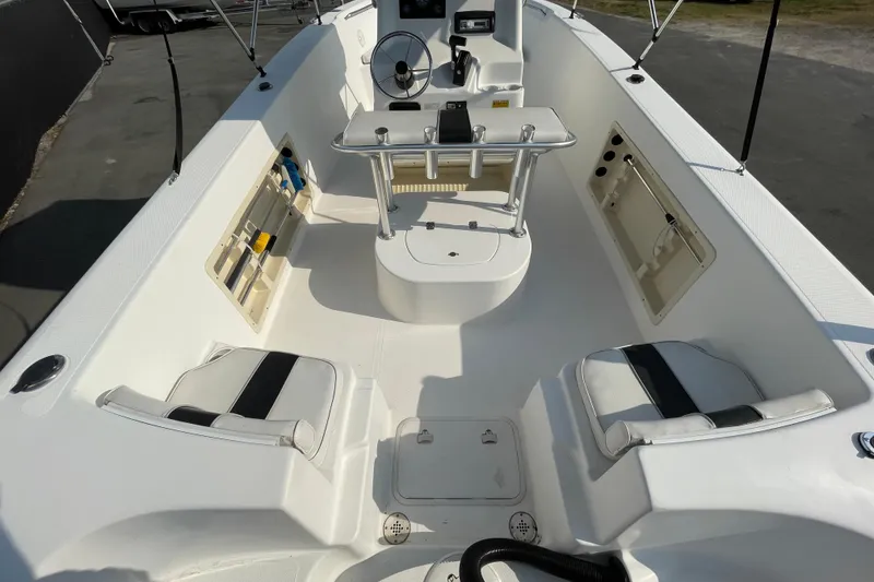 Slide: The Image of 2004 Fishmaster Travis Edition 220 boat interior with seating and steering console. - 11