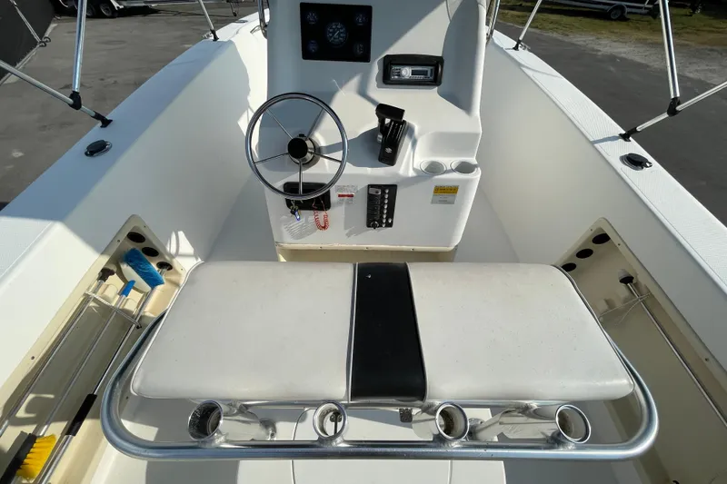 Slide: The Image of 2004 Fishmaster Travis Edition 220 boat interior with steering wheel and seating area. - 19