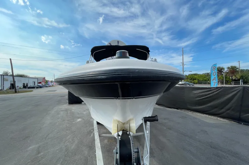 Slide: The Image of 2004 Fishmaster Travis Edition 220 boat on trailer under blue sky. - 2