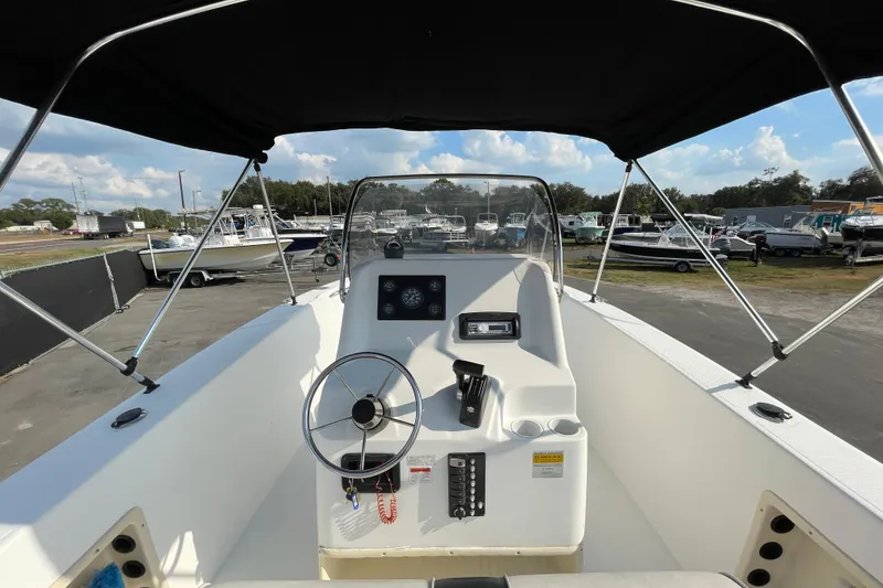 Slide: The Image of 2004 Fishmaster Travis Edition 220 boat interior with steering wheel and control panel. - 21