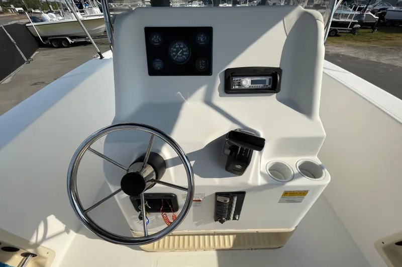 Slide: The Image of 2004 Fishmaster Travis Edition 220 boat console with steering wheel and gauges. - 22