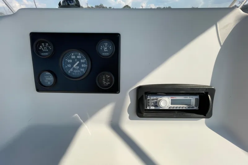 Slide: The Image of Dashboard of 2004 Fishmaster Travis Edition 220 with gauges and stereo system. - 26