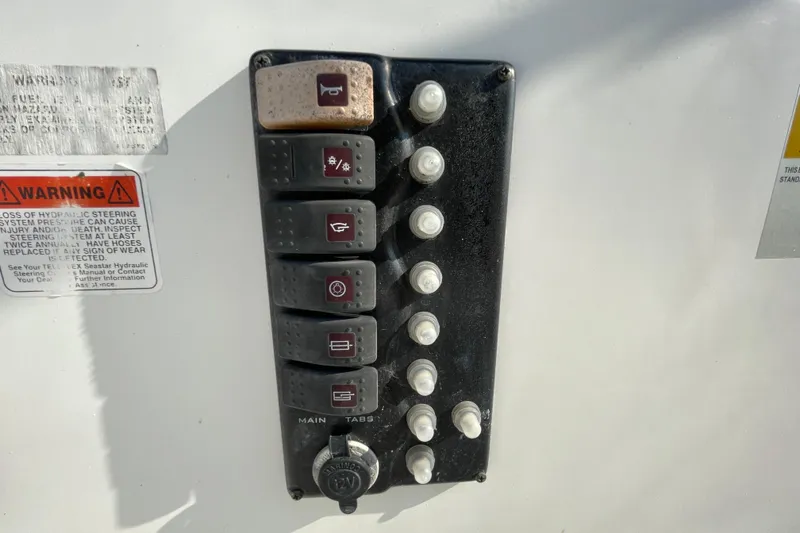 Slide: The Image of Control panel of 2004 Fishmaster Travis Edition 220 boat with warning label. - 27