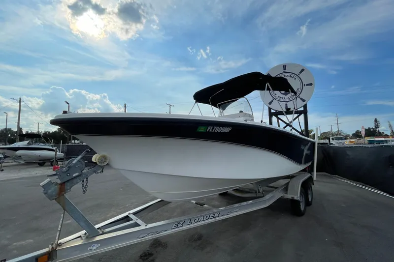 Slide: The Image of 2004 Fishmaster Travis Edition 220 boat on trailer under a cloudy sky. - 3