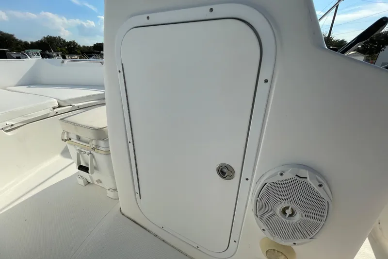 Slide: The Image of 2004 Fishmaster Travis Edition 220 boat interior with storage compartment and speaker. - 30