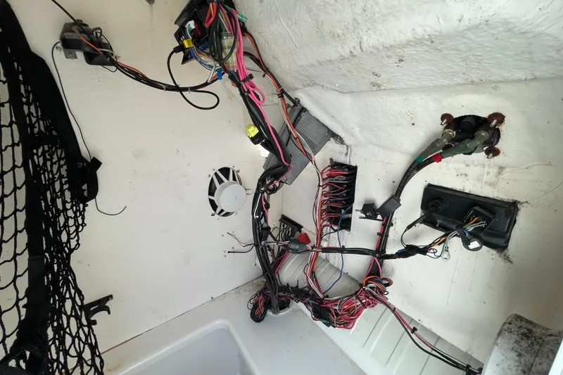 Slide: The Image of Interior wiring of a 2004 Fishmaster Travis Edition 220 boat, showing cables and connections. - 32
