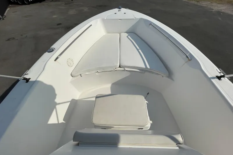 Slide: The Image of 2004 Fishmaster Travis Edition 220 boat interior with white seating and storage. - 33