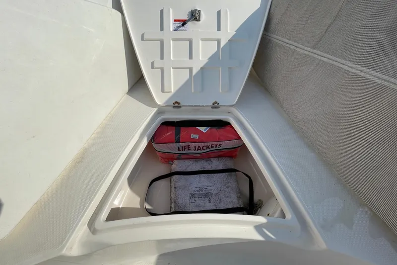 Slide: The Image of Storage compartment on 2004 Fishmaster Travis Edition 220 boat with life jackets inside. - 38