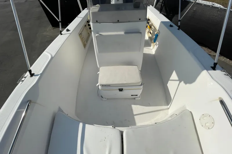 Slide: The Image of 2004 Fishmaster Travis Edition 220 boat interior with seating and storage. - 44