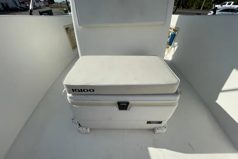 Slide: The Image of 2004 Fishmaster Travis Edition 220 boat with Igloo cooler seat on deck. - 46