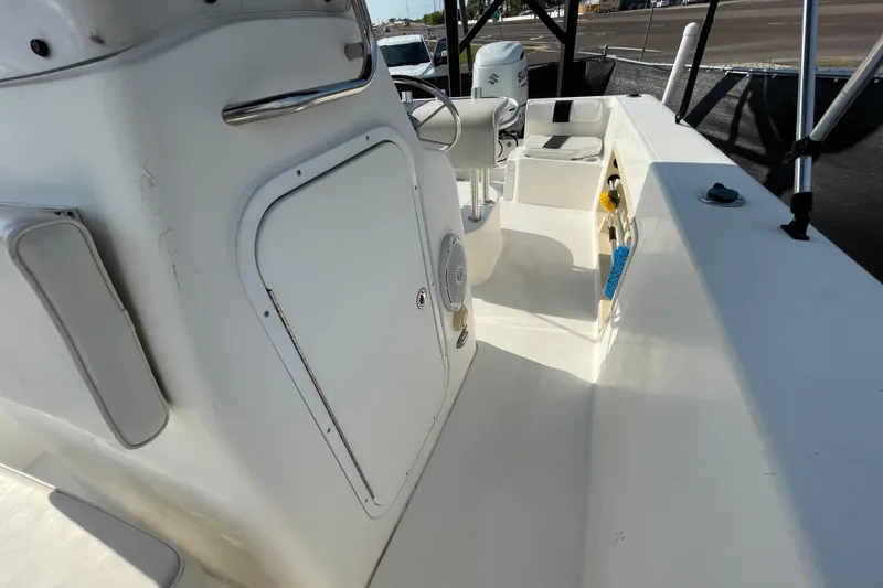 Slide: The Image of 2004 Fishmaster Travis Edition 220 boat interior with steering console and storage compartments. - 48