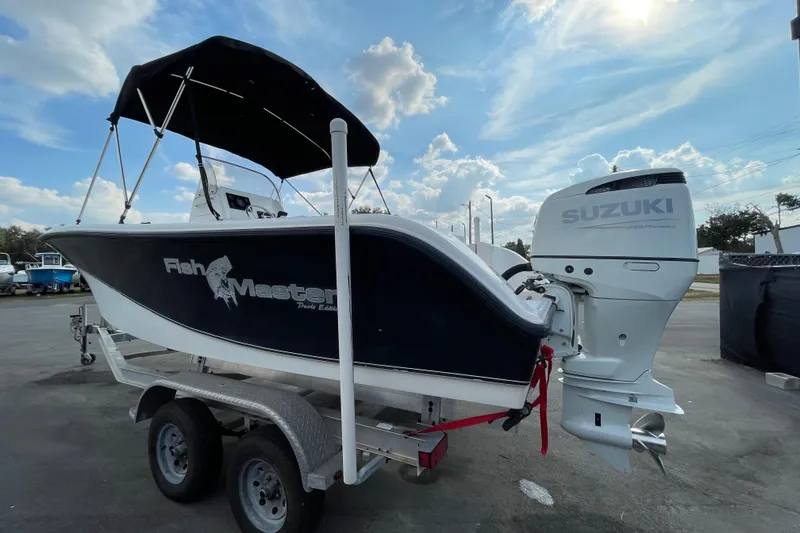 Slide: The Image of 2004 Fishmaster Travis Edition 220 boat with Suzuki outboard motor on trailer. - 5