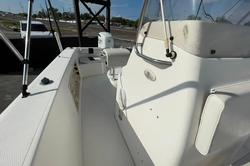 Slide: The Image of 2004 Fishmaster Travis Edition 220 boat interior with seating and controls. - 50
