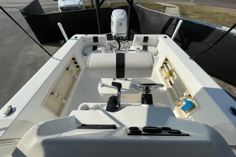 Slide: The Image of 2004 Fishmaster Travis Edition 220 boat interior with steering wheel and storage compartments. - 52