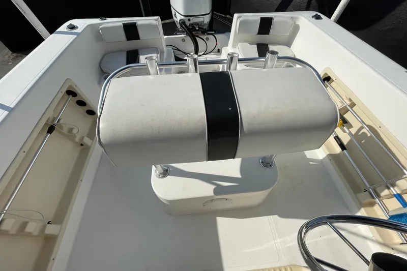 Slide: The Image of 2004 Fishmaster Travis Edition 220 boat interior with seating and steering wheel. - 53