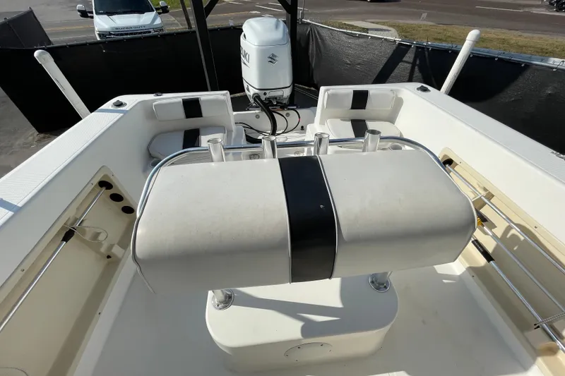 Slide: The Image of 2004 Fishmaster Travis Edition 220 boat interior with seating and Suzuki outboard motor. - 54