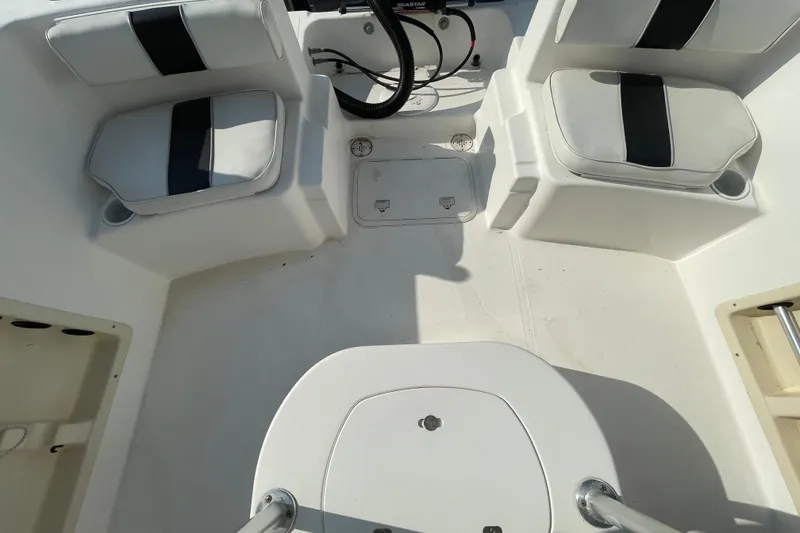 Slide: The Image of 2004 Fishmaster Travis Edition 220 boat interior with seating and steering wheel. - 56