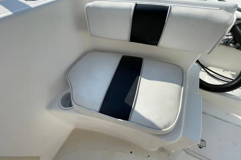 Slide: The Image of White and black cushioned seat on 2004 Fishmaster Travis Edition 220 boat. - 57