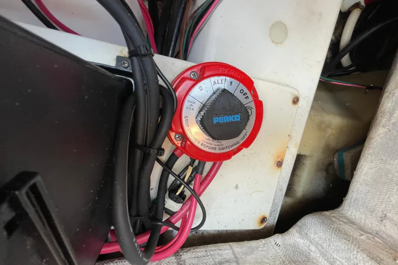 Slide: The Image of Battery switch in a 2004 Fishmaster Travis Edition 220 boat, featuring Perko brand. - 59