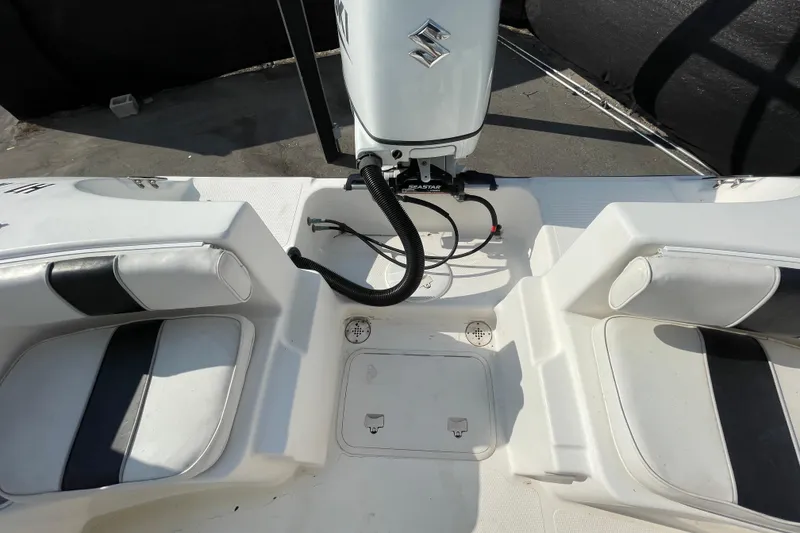 Slide: The Image of 2004 Fishmaster Travis Edition 220 boat interior with seating and Suzuki outboard motor. - 62