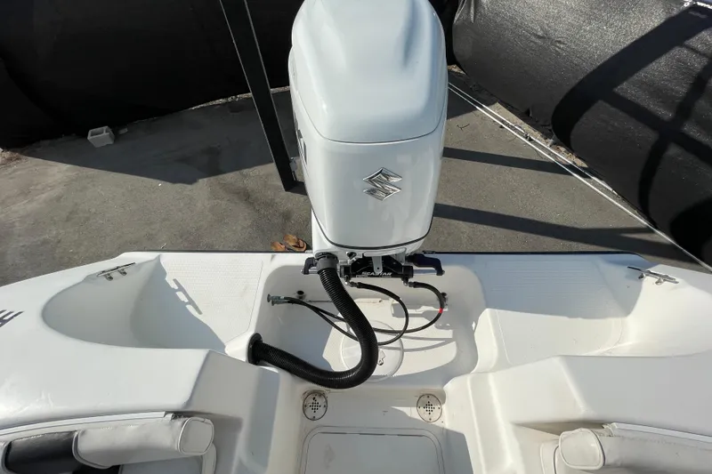 Slide: The Image of 2004 Fishmaster Travis Edition 220 boat with Suzuki outboard motor, rear view. - 63