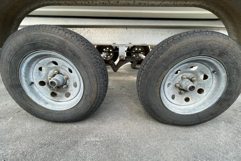 Slide: The Image of Trailer wheels of a 2004 Fishmaster Travis Edition 220 boat on pavement. - 65