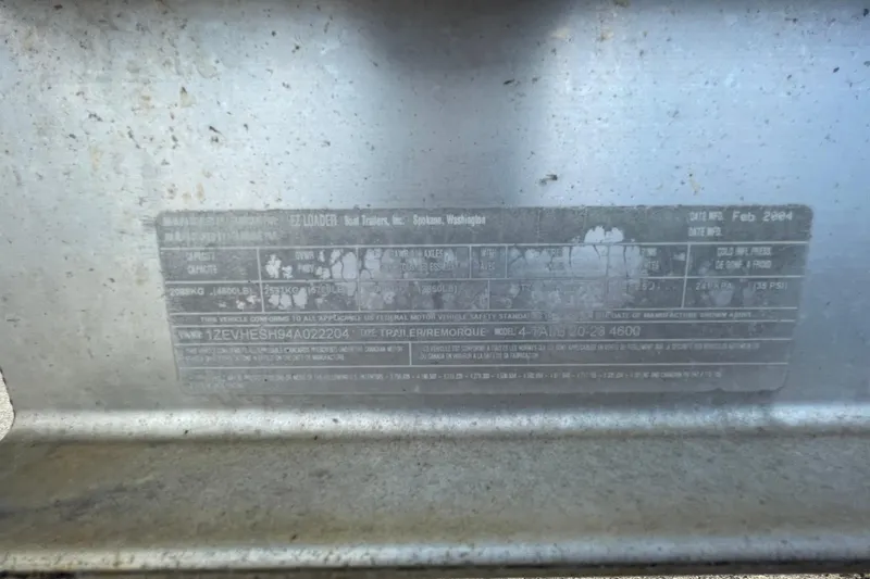 Slide: The Image of Label on a 2004 Fishmaster Travis Edition 220 boat trailer, showing specifications and manufacturing details. - 66
