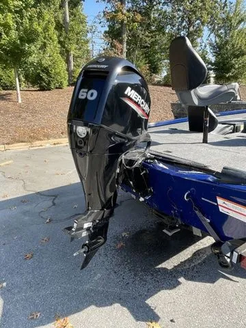 Slide: The Image of 2023 Crestliner XFC 179 boat with Mercury 60 outboard motor, parked outdoors. - 3