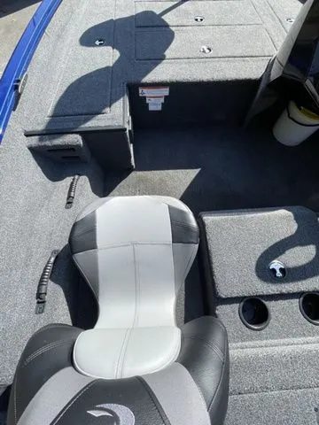 Slide: The Image of 2023 Crestliner XFC 179 boat interior with gray seating and storage compartments. - 8