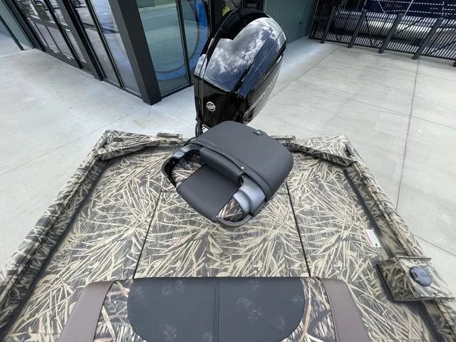 Slide: The Image of 2023 Crestliner 1860 Retriever CC boat with camouflage design and outboard motor. - 10