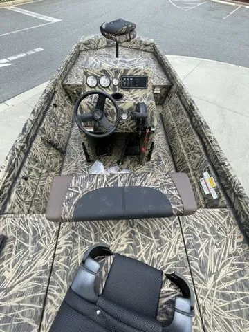 Slide: The Image of 2023 Crestliner 1860 Retriever CC boat with camouflage interior and central steering console. - 4