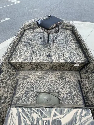 Slide: The Image of 2023 Crestliner 1860 Retriever CC boat with camouflage interior design. - 6