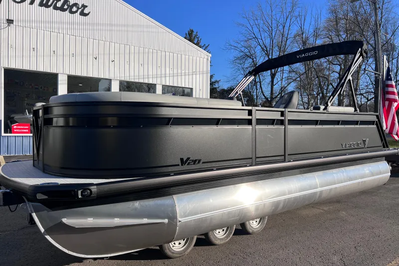Slide: The Image of 2026 Viaggio V 20U pontoon boat parked outside a dealership. - 1