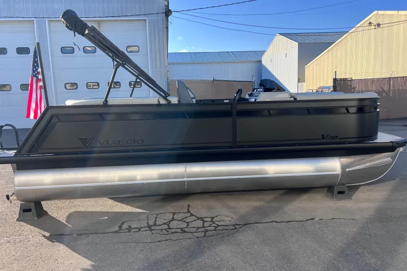 Slide: The Image of 2026 Viaggio V 20U pontoon boat parked outdoors near industrial buildings. - 28