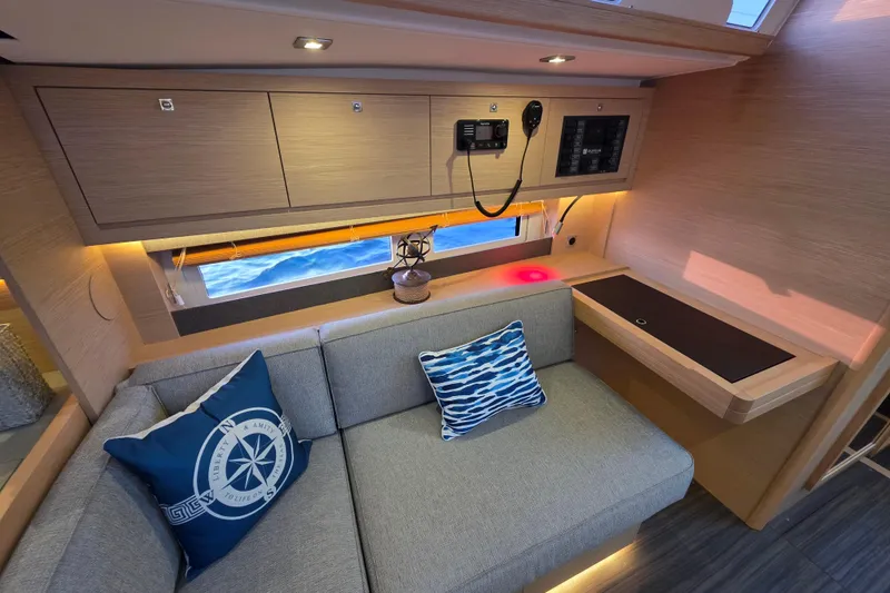 Slide: The Image of 2024 Dufour 530 yacht interior with modern seating and nautical decor. - 11