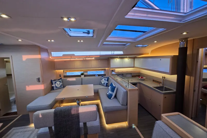 Slide: The Image of Luxurious interior of 2024 Dufour 530 yacht with modern design and spacious seating area. - 12
