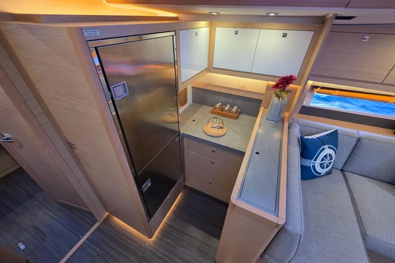 Slide: The Image of Luxurious interior of 2024 Dufour 530 yacht featuring modern kitchen and cozy seating area. - 13