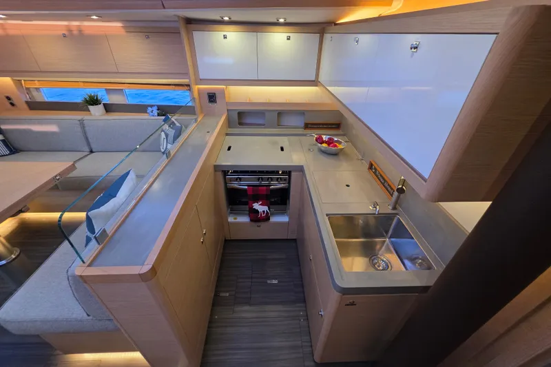 Slide: The Image of Modern kitchen interior of 2024 Dufour 530 yacht with sleek design and ample storage. - 14
