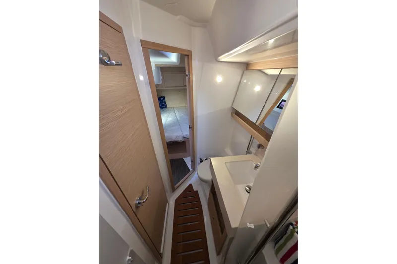 Slide: The Image of 2024 Dufour 530 yacht bathroom with modern fixtures and wooden accents. - 18