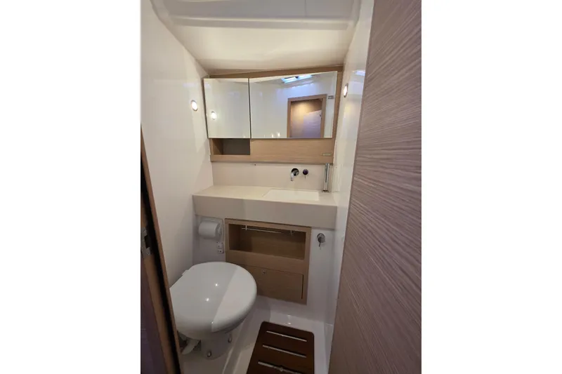 Slide: The Image of 2024 Dufour 530 yacht bathroom with modern fixtures and wooden accents. - 19