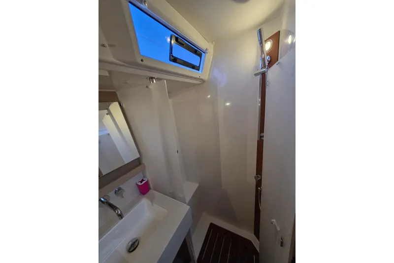 Slide: The Image of 2024 Dufour 530 yacht bathroom with modern fixtures and skylight. - 20