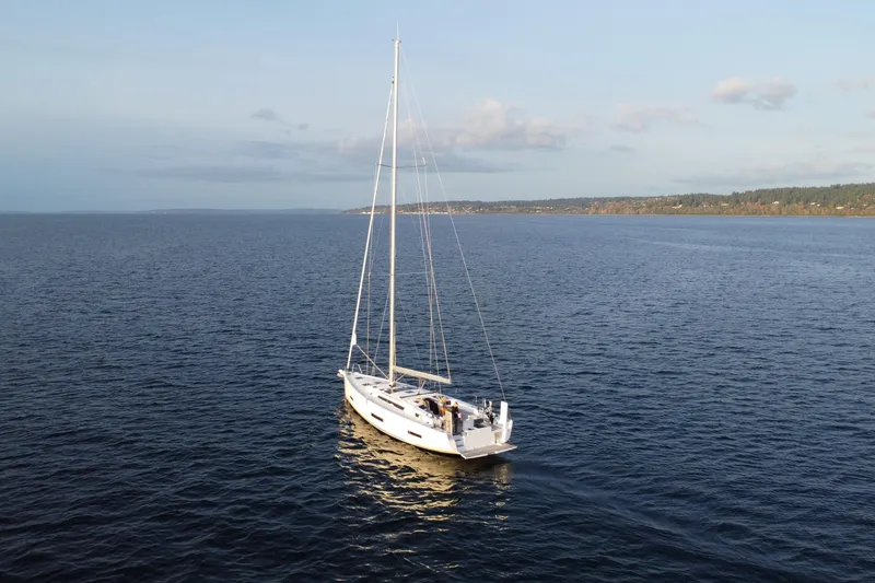 Slide: The Image of 2024 Dufour 530 sailboat cruising on open water under a clear sky. - 23