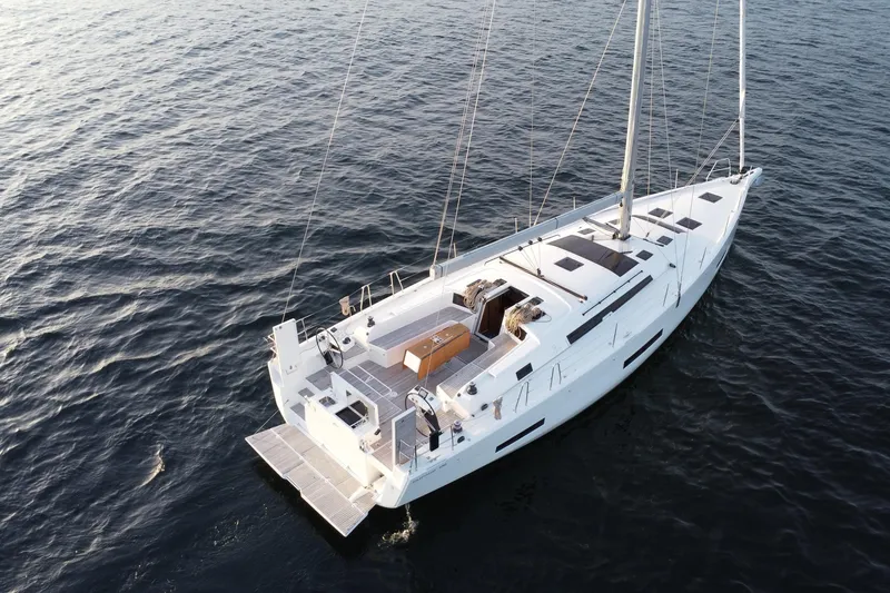 Slide: The Image of 2024 Dufour 530 yacht sailing on calm ocean waters. - 5