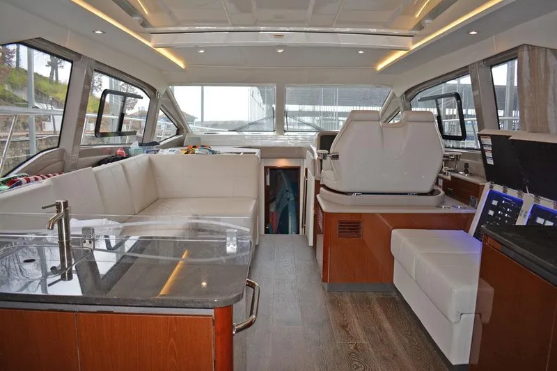 Slide: The Image of Helm of 2017 Sea Ray Sundancer 460 with navigation screens and controls. - 16