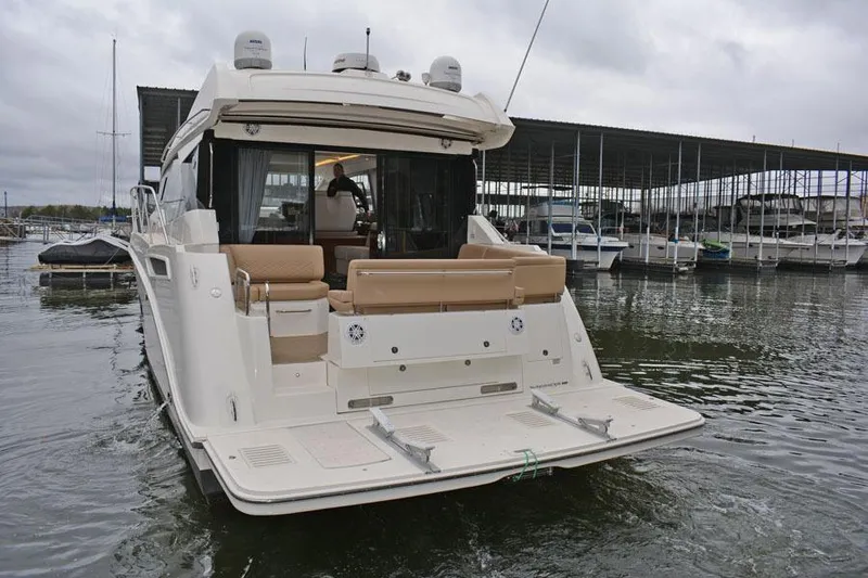 Slide: The Image of 2017 Sea Ray Sundancer 460 interior with beige leather seating and quilted design. - 28