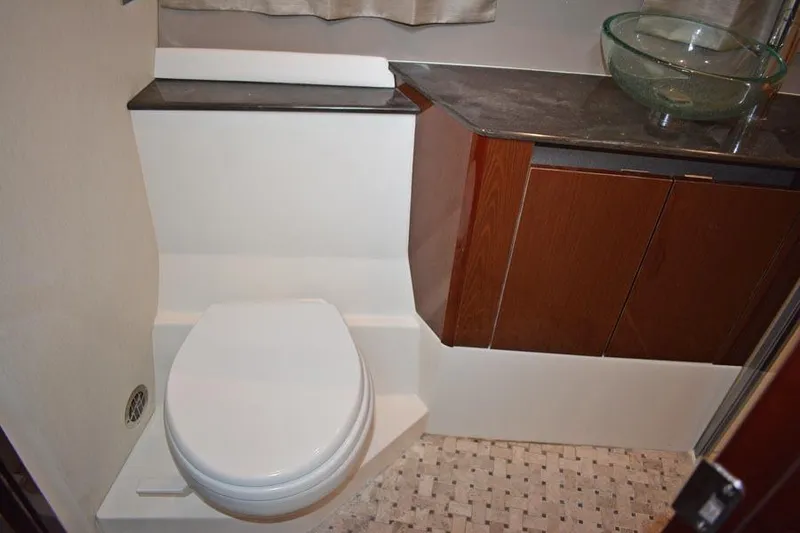 Slide: The Image of 2017 Sea Ray Sundancer 460 yacht docked, sun reflecting on calm water. - 43