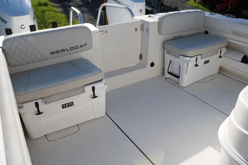 Slide: The Image of 2024 World Cat 325 CC boat interior with Yeti coolers and cushioned seating. - 11